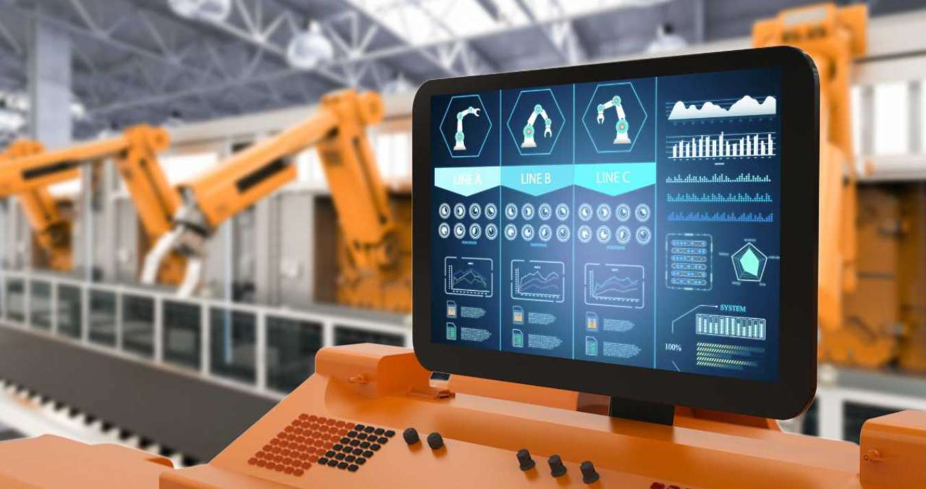 Imagem de maquinário industrial acoplado a uma tela digital com gráficos