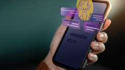Uma mão humana segurando um celular com frases e figura em 3D saindo da tela